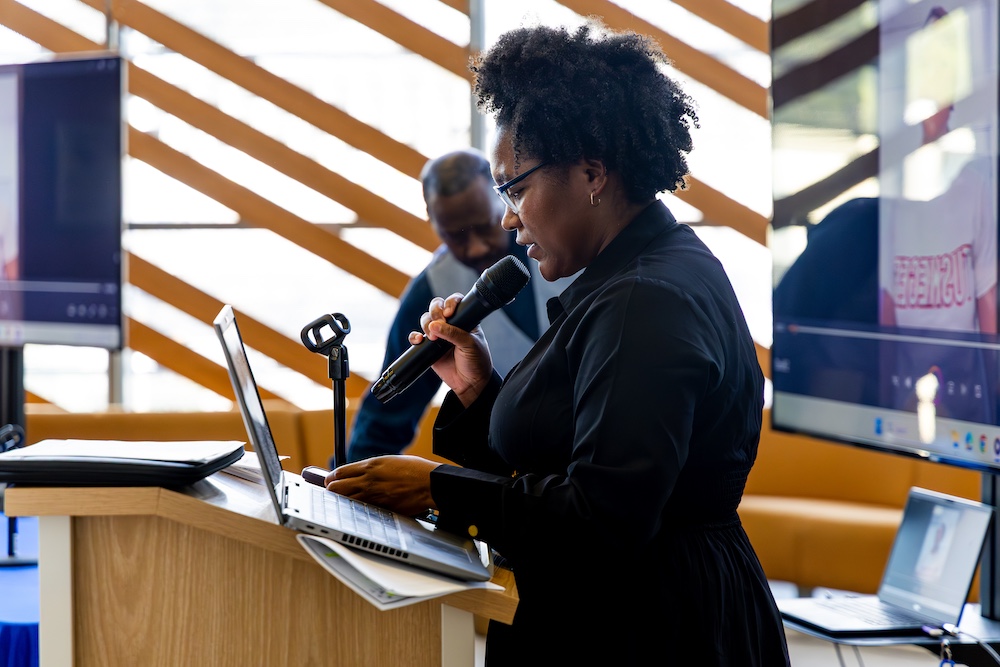 Sade Johnson speaking at podium