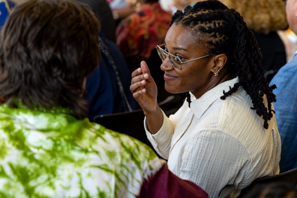 Image of Black event in the ellipse gallery two people in the audience conversating