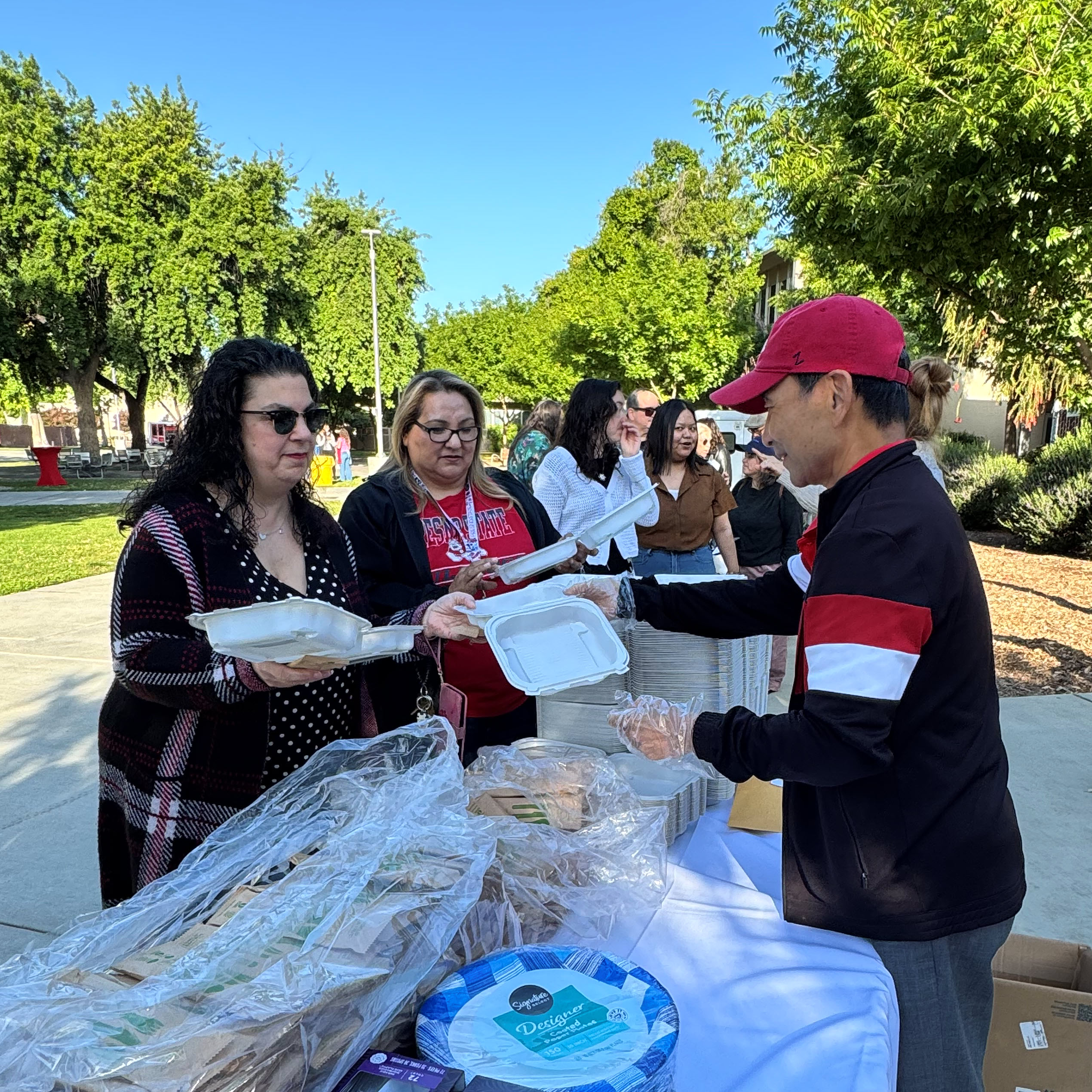 Provost Fu handing out breakfast plates