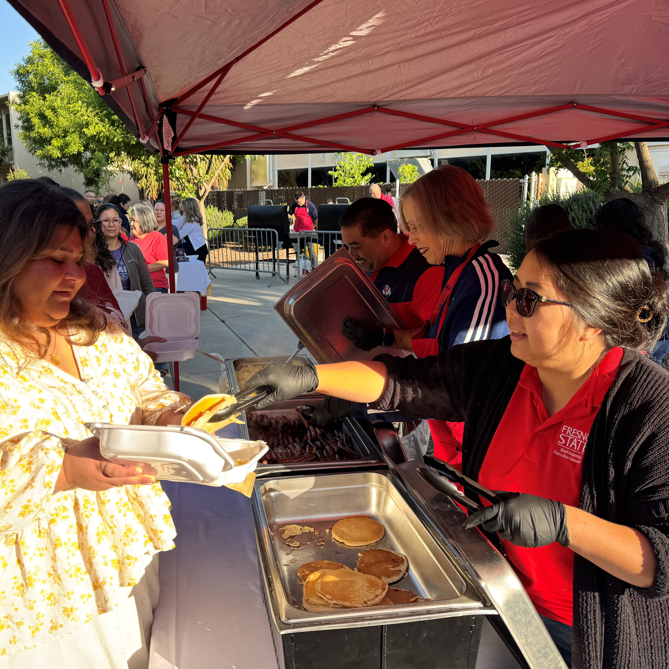 People in line being served breakfast