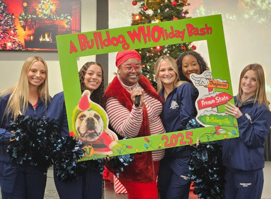 Dean of Students and Cheer Team with Grinch photo frame